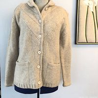 Front view of wool cardigan on mannequin
