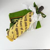 Both rolled towels wrapped around wine bottle