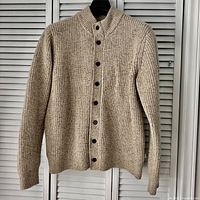 Full front view of beige rib knit cardigan on hanger