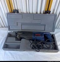 Ryobi reciprocating saw inside grey plastic carry case, full view