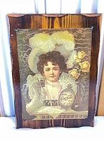 Full view of laminated Coca-Cola advert on wood plaque