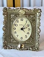 Full view of ornate silver-tone Seth Thomas alarm clock