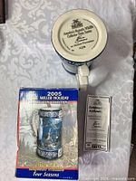 underside of stein showing makers mark, box, certificate