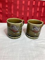 Front view of both Wade demitasse cups showing pheasant motif