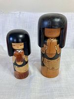 Front view of both Kokeshi dolls standing upright