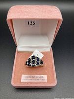 Open presentation box displaying sterling silver sapphire ring