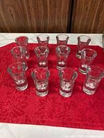 Twelve shooter glasses displayed upright
