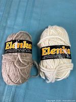 Two skeins Elenka Icelandic Type wool yarn showing labels and colours