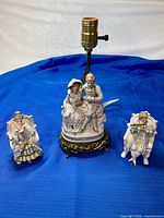 Lamp and two figurines grouped