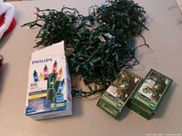 Boxed Philips lights and two green-box sets next to three loose strands
