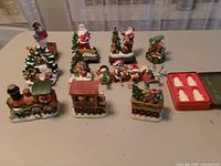 Group shot of all ceramic figurines, train pieces and soap tray