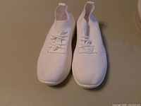 top view of pair of white mesh sneakers