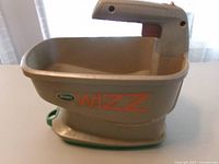 Left side view showing Scotts Wizz logo and hopper