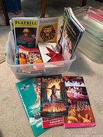 Plastic tote filled with assorted Playbill and other programs