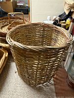 Tall round basket with other baskets partially visible