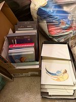 Two boxes filled with Hallmark boxed card sets and loose cards