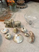 Group view showing onyx candle holders, fruit, soapstone bookends, glass compote and tray