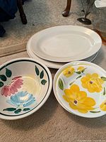 White oval platters and two hand-painted ceramic bowls