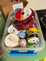 Top view of bin filled with assorted ribbon spools