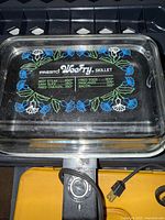 Glass lid of Presto WeeFry skillet showing floral design and temperature guide