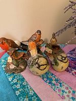 Group shot of three Royal Doulton Garden Birds figurines with two shown bottom-up