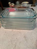 Stack of five clear glass rectangular baking dishes