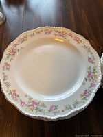 Single plate front showing floral rim and scalloped edge