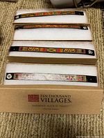 Four boxed leather bracelets in original Ten Thousand Villages packaging