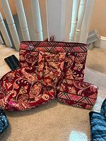 Tote bag, wallet and additional matching pieces on carpeted stair landing