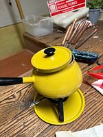 overall view of fondue pot on stand with forks inserted