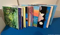 Front view of stack of painted 16"x20" canvases