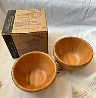 Both bamboo bowls next to original Pampered Chef box