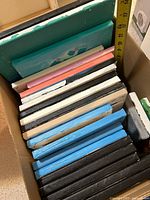 Open box showing stacked canvases, measuring tape indicates largest about 14 in.