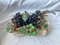 decorative grapes arranged in ceramic basket
