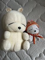 Front view of both Mashimaro plush dolls