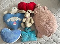 Group shot of all six plush pillows and toys