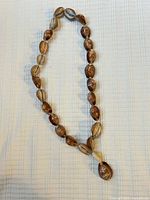 Full view of cowrie shell necklace laid flat
