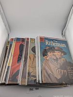 Stack of bagged Dell western comics, top issue The Rifleman