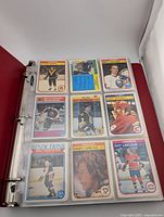 Open binder showing first page of 1982 O-Pee-Chee hockey cards