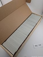 Cardboard box filled with tightly packed trading cards