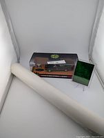 Rolled poster, boxed Batmobile die-cast with figure, holographic card in stand