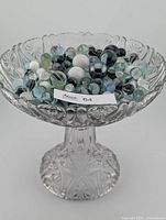 Footed glass compote filled with assorted marbles
