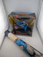 Boxed Batman figure with rolled poster in front