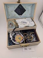 Open jewelry box showing assorted jewelry inside