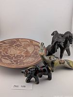Group shot: etched plate, Tonala bird, redware donkey, Oaxaca black pottery figurine