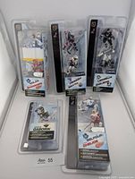 Front view of five sealed McFarlane NHL mini figure packs showing all players