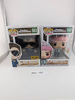 Front view of both boxed Funko Pop figures