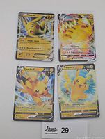 Front view of four Pikachu cards in sleeves