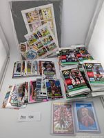 Overall lot showing sealed packs, loose cards and stamp sheet
