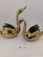Front view of both brass swan planters